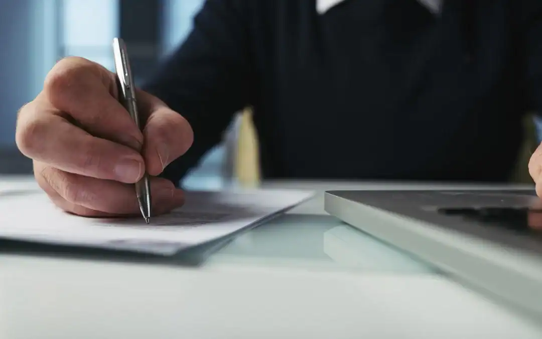 Cyprus company director reviewing audited financial statements at his desk, prepared by Iacovou and Co chartered accountants in Limassol
